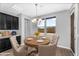 Cozy dining area featuring a round table, comfortable seating, modern lighting, and a view of the neighborhood at 22131 E Estrella Rd, Queen Creek, AZ 85142