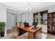 Bright home office featuring a wooden desk, modern lighting, and an open view, perfect for a productive work environment at 22131 E Estrella Rd, Queen Creek, AZ 85142