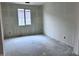 An unfinished bedroom features natural light, a modern window, and electrical wiring ready for customization at 32155 N Lone Rancher Way, San Tan Valley, AZ 85140