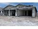New construction home featuring a covered front porch with stately columns and an attached two-car garage at 32155 N Lone Rancher Way, San Tan Valley, AZ 85140