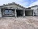 New construction home featuring a covered front porch with stately columns and an attached two-car garage at 32155 N Lone Rancher Way, San Tan Valley, AZ 85140