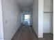 Hallway of new home that leads to a sliding glass door, tile floor, and a closet at 32155 N Lone Rancher Way, San Tan Valley, AZ 85140