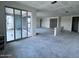 Unfinished living room with large glass patio doors, recessed lighting, and ample space for customization at 32155 N Lone Rancher Way, San Tan Valley, AZ 85140