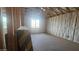 Unfinished room featuring insulation, framing, and a large window at 32155 N Lone Rancher Way, San Tan Valley, AZ 85140
