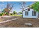 Large backyard featuring bare trees, brick paths, the back of the house and a grassy field at 4333 N 15Th Dr, Phoenix, AZ 85015