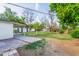 Green backyard featuring a blend of lush lawn, mature trees, and a quaint detached structure at 4333 N 15Th Dr, Phoenix, AZ 85015