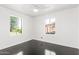 A bright bedroom with a ceiling fan and two windows letting in natural light at 4333 N 15Th Dr, Phoenix, AZ 85015