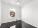 Bedroom featuring a ceiling fan, black floors, and a window for natural light at 4333 N 15Th Dr, Phoenix, AZ 85015