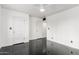 Clean, bright bedroom featuring sleek black floors, white walls and ceiling fan at 4333 N 15Th Dr, Phoenix, AZ 85015