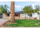 Charming single-story home with a well-maintained lawn, rock accents, and mature palm trees at 4333 N 15Th Dr, Phoenix, AZ 85015