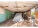 Spacious garage featuring wooden beams, a covered car, and mixed wall materials at 4333 N 15Th Dr, Phoenix, AZ 85015
