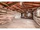 Open garage interior featuring wooden ceiling beams and a mix of wood and plywood walls at 4333 N 15Th Dr, Phoenix, AZ 85015