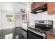 Modern kitchen featuring stainless steel appliances, white cabinetry, and sleek black floors at 4333 N 15Th Dr, Phoenix, AZ 85015