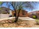 Gravel backyard featuring a mature tree, partial patio, and block fence offering privacy at 1384 E Press Rd, San Tan Valley, AZ 85140