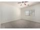 Bright bedroom with neutral carpet, ceiling fan, and window at 1384 E Press Rd, San Tan Valley, AZ 85140