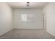 Neutral carpet, window, and attached door in bedroom at 1384 E Press Rd, San Tan Valley, AZ 85140
