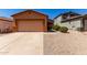 Inviting single-story home with a well-maintained front yard and two-car garage, perfect for a Gathering at 1384 E Press Rd, San Tan Valley, AZ 85140