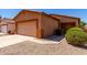 Charming single-story home with a two-car garage, desert landscaping, and a cozy front entrance at 1384 E Press Rd, San Tan Valley, AZ 85140