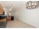 Bright kitchen featuring dark countertops, oak cabinets and tile flooring with open access to the living space at 1384 E Press Rd, San Tan Valley, AZ 85140