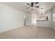 Spacious living room with open layout, neutral tile, ceiling fan, and seamless flow into dining area at 1384 E Press Rd, San Tan Valley, AZ 85140