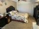 Bedroom with floral comforter, dark wood furniture, ceiling fan, and window with horizontal blinds at 17431 N Boswell Blvd, Sun City, AZ 85373
