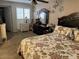 Cozy bedroom featuring a floral comforter, dark wood furniture, ceiling fan, and bright, shuttered windows at 17431 N Boswell Blvd, Sun City, AZ 85373