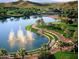 Scenic aerial view of a community lake with water fountains and landscaping at 18001 W Cassia Way, Goodyear, AZ 85338