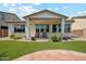 Beautiful backyard featuring a covered patio and landscaped yard at 18001 W Cassia Way, Goodyear, AZ 85338