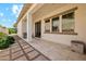 Covered patio featuring a tiled walkway, neutral siding, and well-manicured landscaping, perfect for outdoor relaxation at 18001 W Cassia Way, Goodyear, AZ 85338