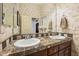 Charming bathroom featuring a marble countertop and decorative wallpaper at 18001 W Cassia Way, Goodyear, AZ 85338