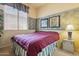 Cozy bedroom showcasing a plush bed, floral accents and natural light at 18001 W Cassia Way, Goodyear, AZ 85338