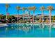 Relaxing community pool with umbrellas and seating in front of the clubhouse at 18001 W Cassia Way, Goodyear, AZ 85338