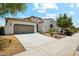 Single-Gathering home featuring stucco siding, a tile roof, landscaped front yard, and a two-car garage at 18001 W Cassia Way, Goodyear, AZ 85338