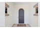 Elegant front door with arched detailing and tiled entryway at 18001 W Cassia Way, Goodyear, AZ 85338