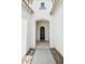 Covered front porch that leads to a arched entryway with clean and neutral finishes at 18001 W Cassia Way, Goodyear, AZ 85338