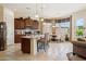 Well-appointed kitchen featuring granite countertops, stainless steel appliances, and center island with seating at 18001 W Cassia Way, Goodyear, AZ 85338