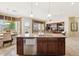 Modern kitchen featuring island, pendant lighting, and breakfast bar seating with sightlines to the living room at 18001 W Cassia Way, Goodyear, AZ 85338