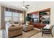 Cozy living room featuring large windows, and custom built-ins at 18001 W Cassia Way, Goodyear, AZ 85338