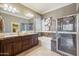 Elegant main bathroom boasts double sinks, separate tub, and a glass enclosed shower at 18001 W Cassia Way, Goodyear, AZ 85338