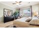 Comfortable main bedroom features soft lighting, a large window, and neutral decor at 18001 W Cassia Way, Goodyear, AZ 85338