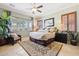 Spacious main bedroom with ceiling fan, natural light, neutral color palette, and plush rug at 18001 W Cassia Way, Goodyear, AZ 85338