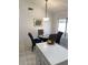 Bright dining area with tile floors, a modern light fixture, and seating for four at 1833 E Bluefield Ave, Phoenix, AZ 85022