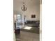 Cozy living room featuring tile floors, a chandelier, and a comfortable grey sofa at 1833 E Bluefield Ave, Phoenix, AZ 85022