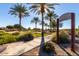 Beautiful community entrance with palm trees, landscaping, and a sign for Meridian at 23145 E Via Las Brisas --, Queen Creek, AZ 85142