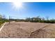Community volleyball court with net and sand, surrounded by well-maintained landscaping at 23145 E Via Las Brisas --, Queen Creek, AZ 85142