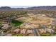 This aerial view showcases a neighborhood park featuring baseball fields and a playground, framed by mountain views on the horizon at 2305 N Heritage St, Buckeye, AZ 85396