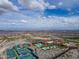 Aerial view showcases community tennis courts, clubhouse, and pool with lush landscaping at 2305 N Heritage St, Buckeye, AZ 85396