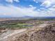 Expansive aerial showcasing a golf course and highway near new community with mountains in background on a sunny day at 2305 N Heritage St, Buckeye, AZ 85396