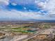 Stunning aerial view of a golf course community with a blue sky and beautiful mountain backdrop at 2305 N Heritage St, Buckeye, AZ 85396
