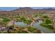 Stunning aerial view of the golf course community with lush fairways and sparkling lakes, surrounded by mountain views at 2305 N Heritage St, Buckeye, AZ 85396